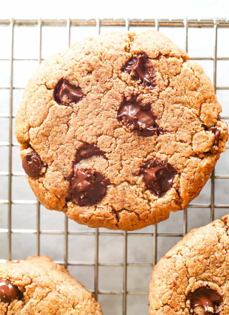 close up of a chocolate chip cookie on a cooling rack