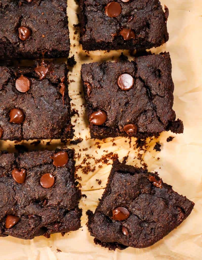 six vegan gluten free brownies on parchment paper