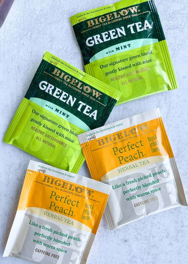 four tea bags: two mint green tea and two peach teas