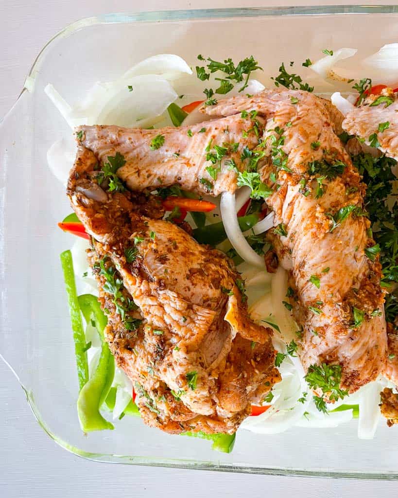 uncooked, seasoned turkey wings in a dish