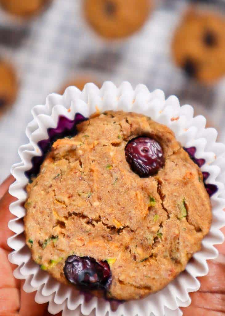 close up of the top of a zucchini blueberry muffin