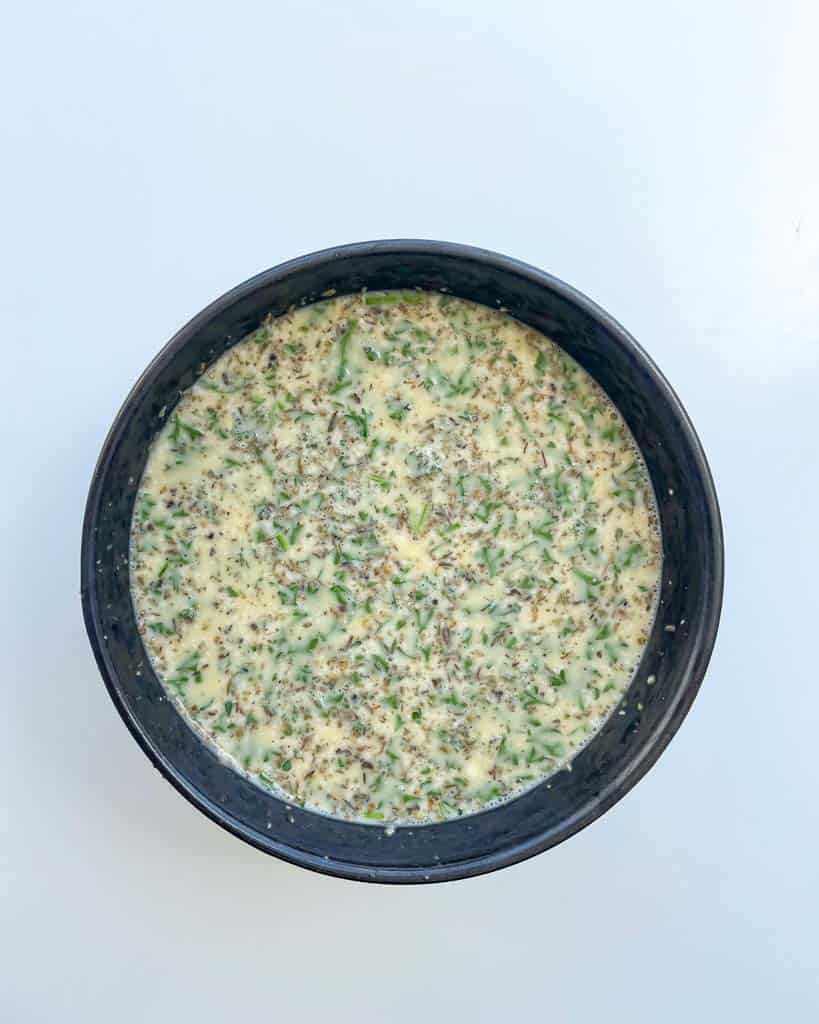 overhead view of egg mixture for. gluten-free strata recipe