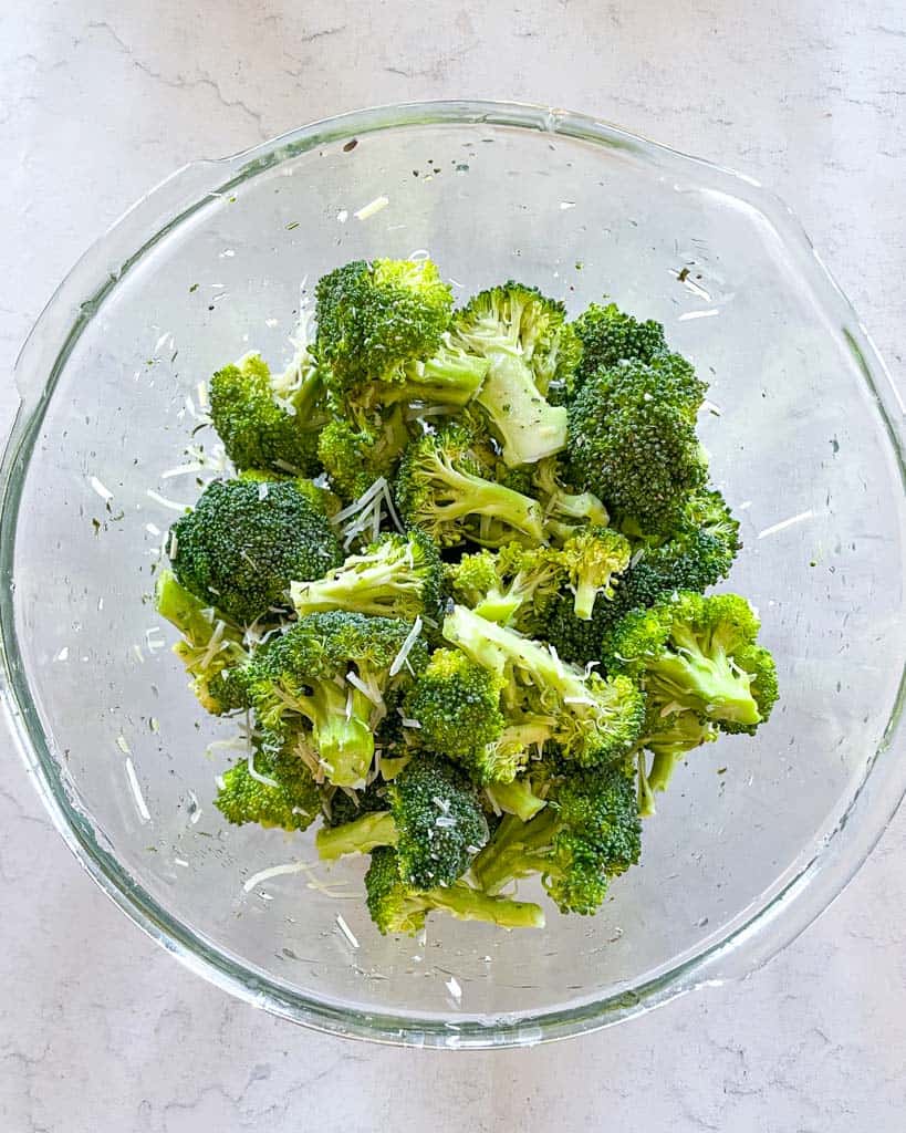 tossed and seasoned broccoli in a bowl