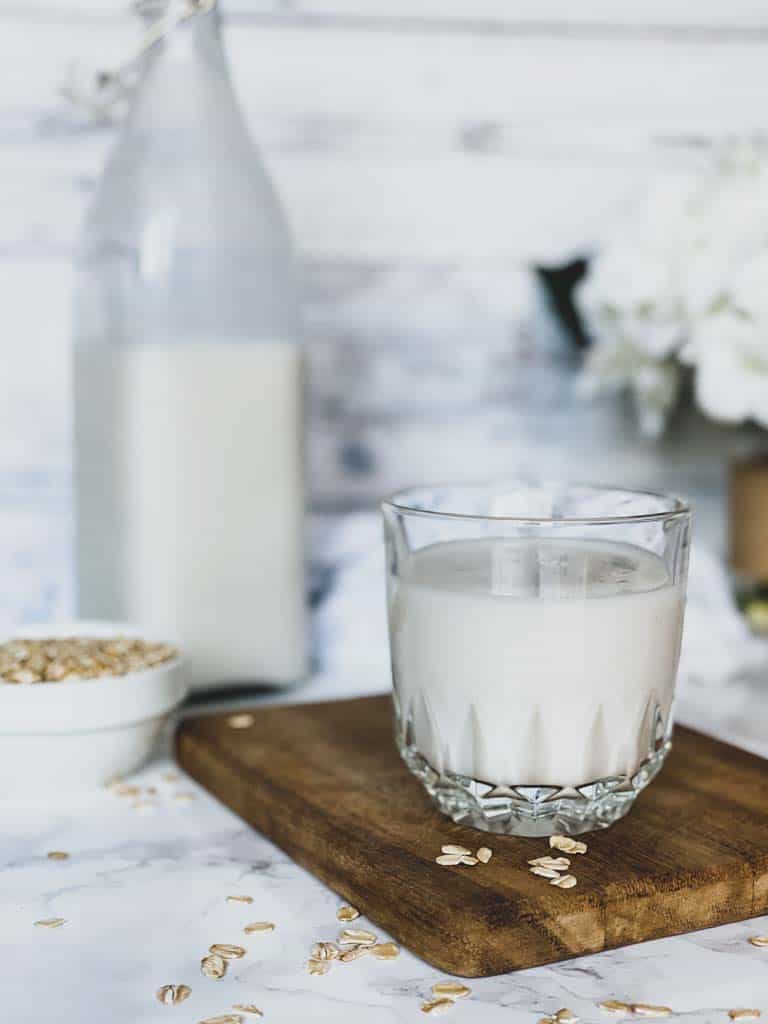 homemade oat milk on a wooden cutting board