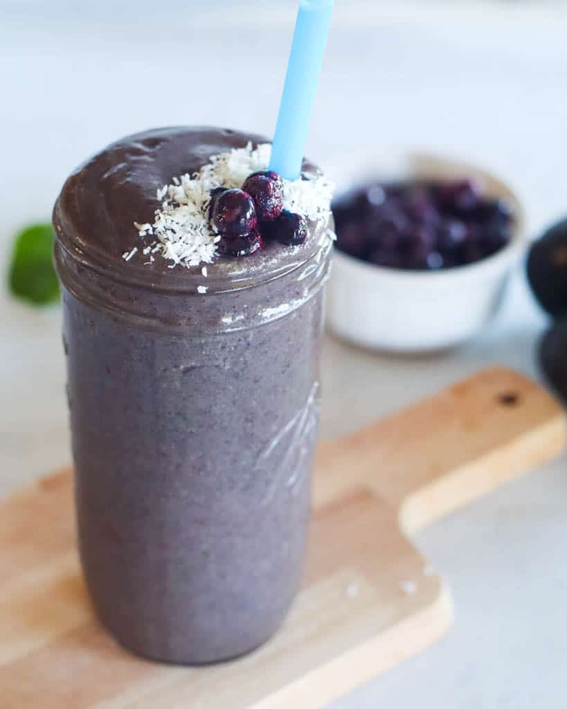 cup of post workout smoothie topped with blueberries