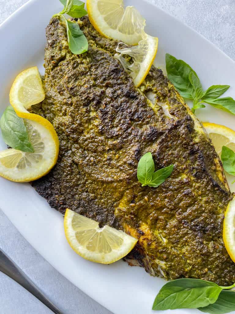 close up view of plated pesto-crusted broiled sea bass