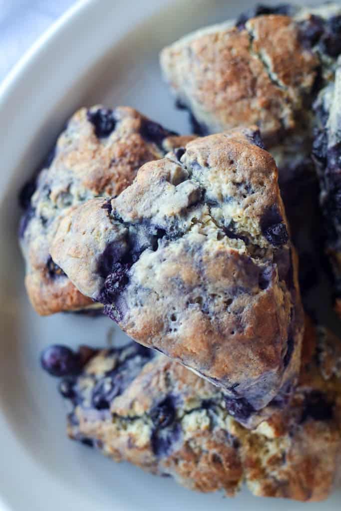 close up view of a half a plate of blueberry scones