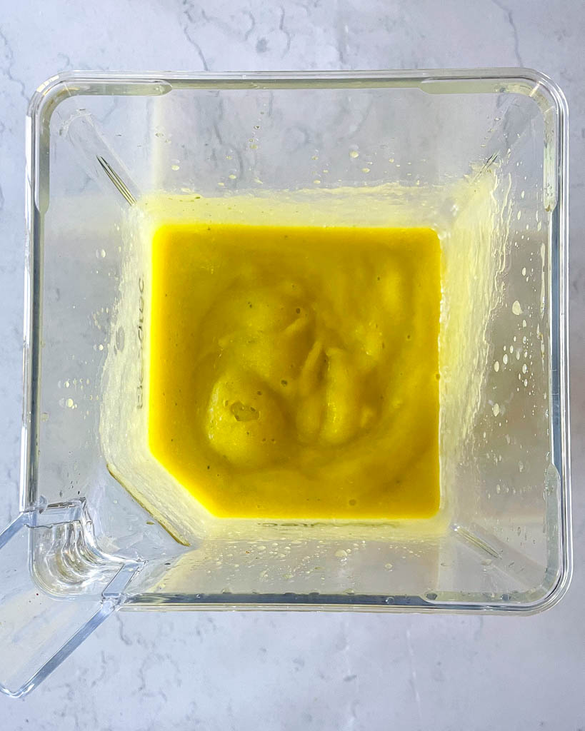 overhead view of pineapple mango smoothie in a blender