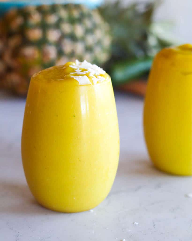 one glass full of mango pineapple smoothie