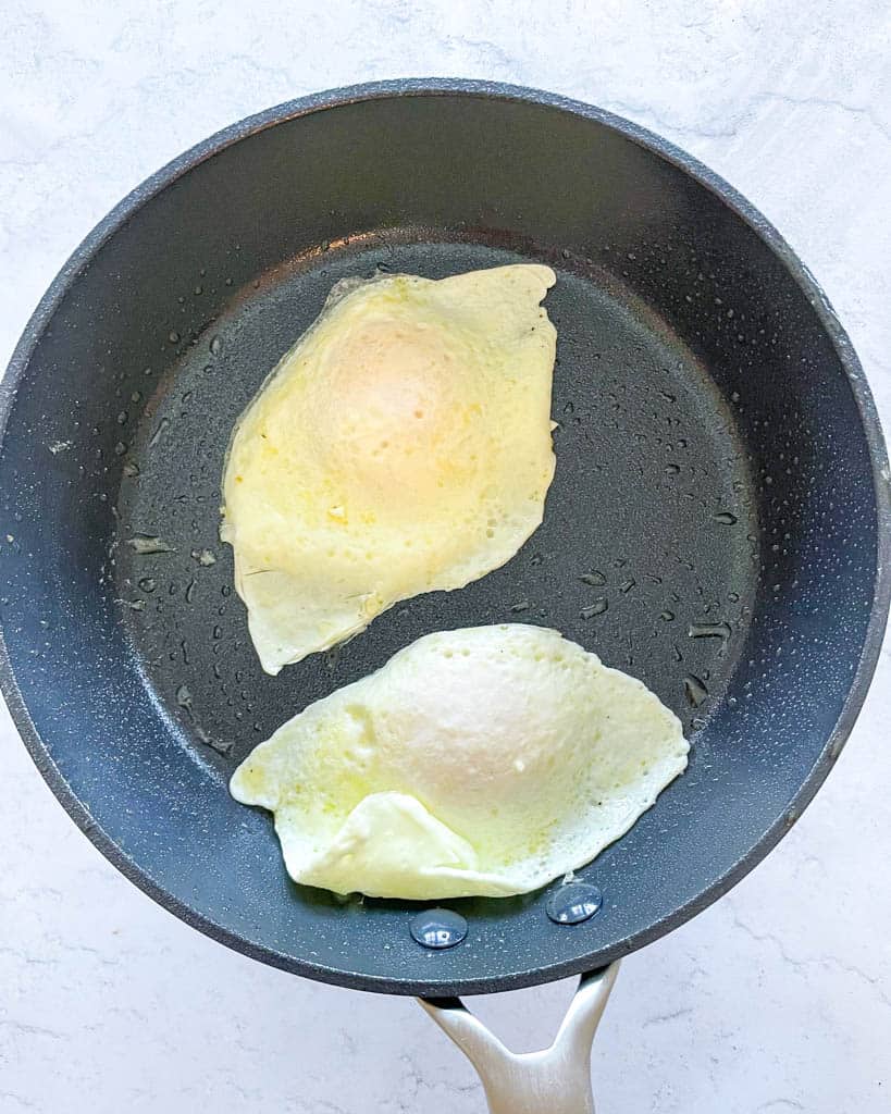 eggs fried over easy in a non-stick pan