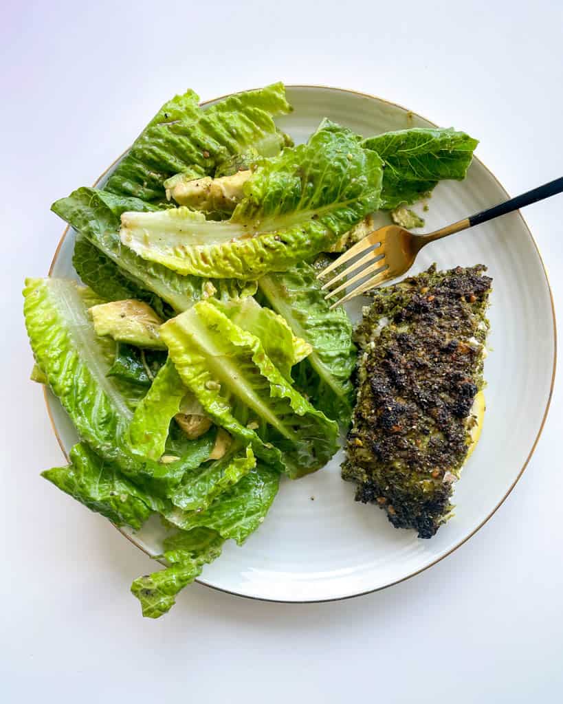 Pesto Crusted Sea Bass On A Plate with salad 
