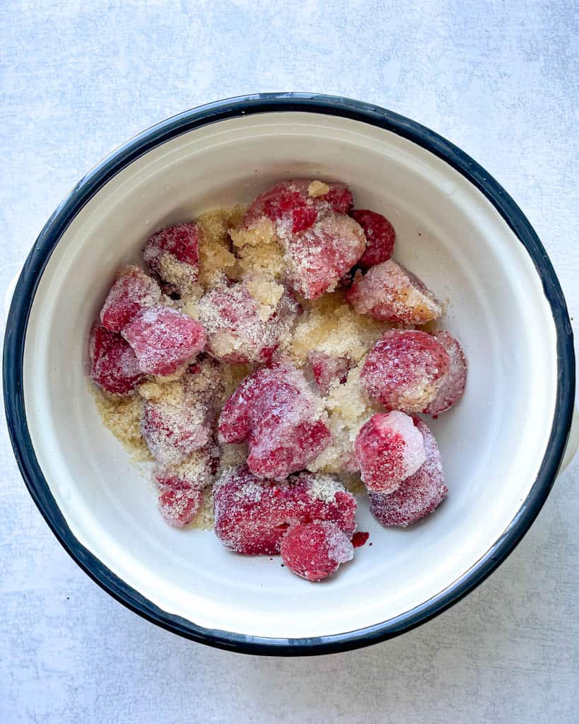 strawberries covered with sugar in a pot