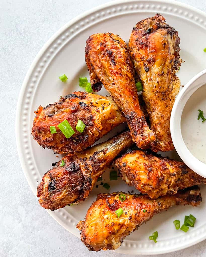 overhead view of plated air fryer drumsticks with dipping sauce