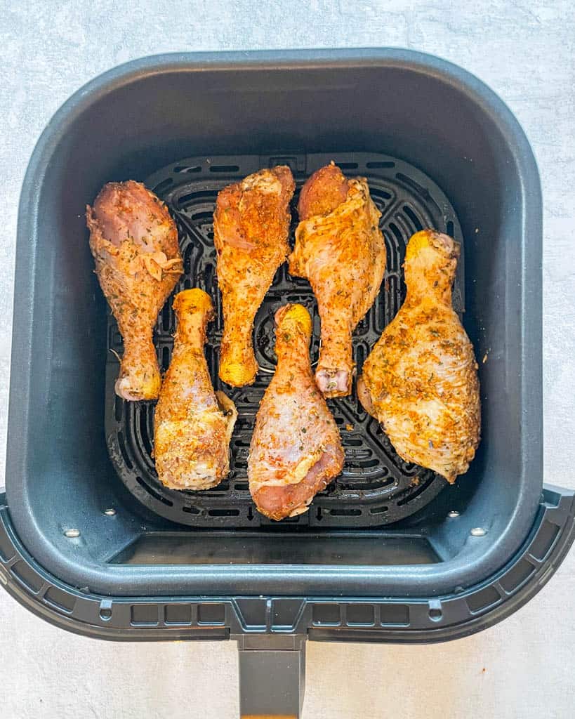 overhead view of raw drumsticks in an air fryer