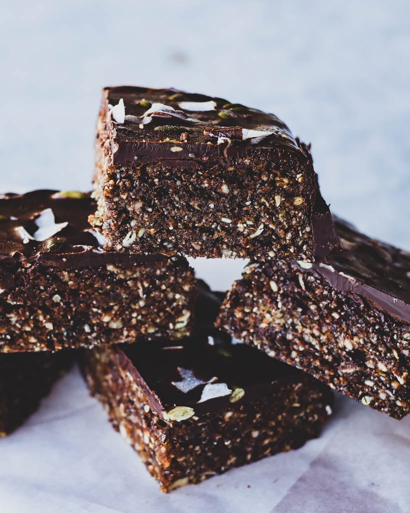 a stack of sliced superfood bars close up to show texture of nuts and seeds