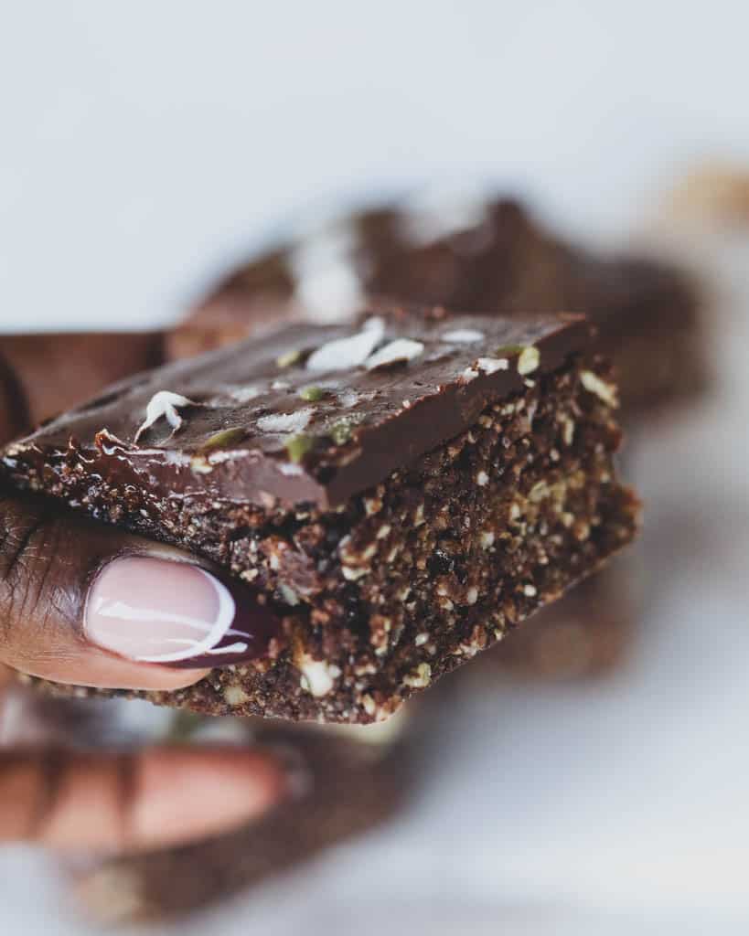 Close up shot of hand holding a sliced energy bar 