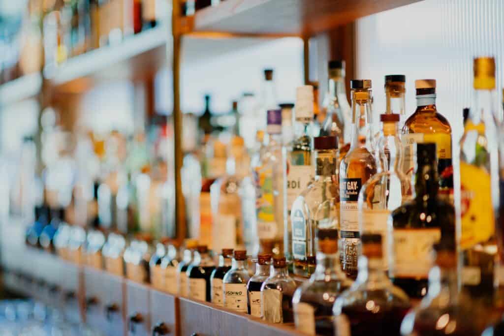 an assortment of alcohol on the shelf