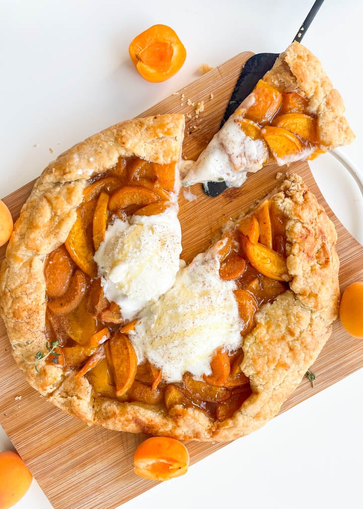 homemade gluten free apricot galette  sliced with ice cream on top