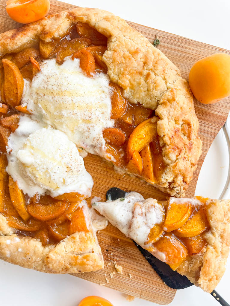 sliced apricot galette with ice cream on top