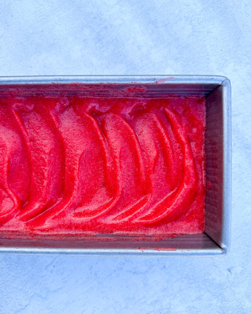 a container full of strawberry sorbet