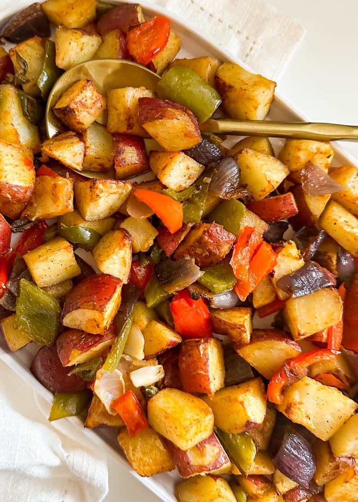 home fries on a platter with a spoon