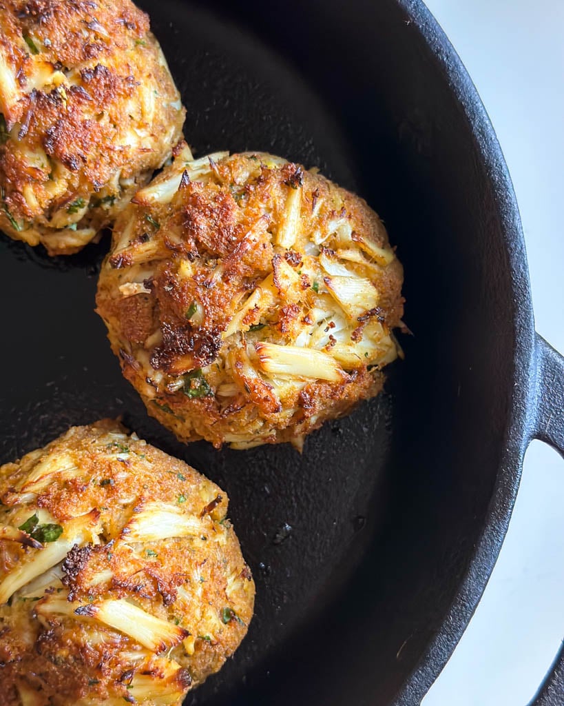 close up of baked Maryland crab cakes in skillet