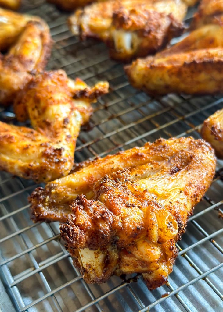 close up view of chicken wings on a cooling