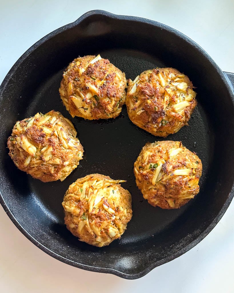 five baked crab cakes in a skillet