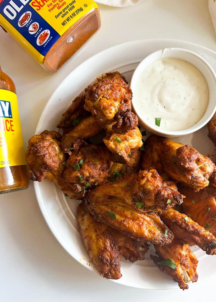 plated old bay wings with a side of dipping sauce