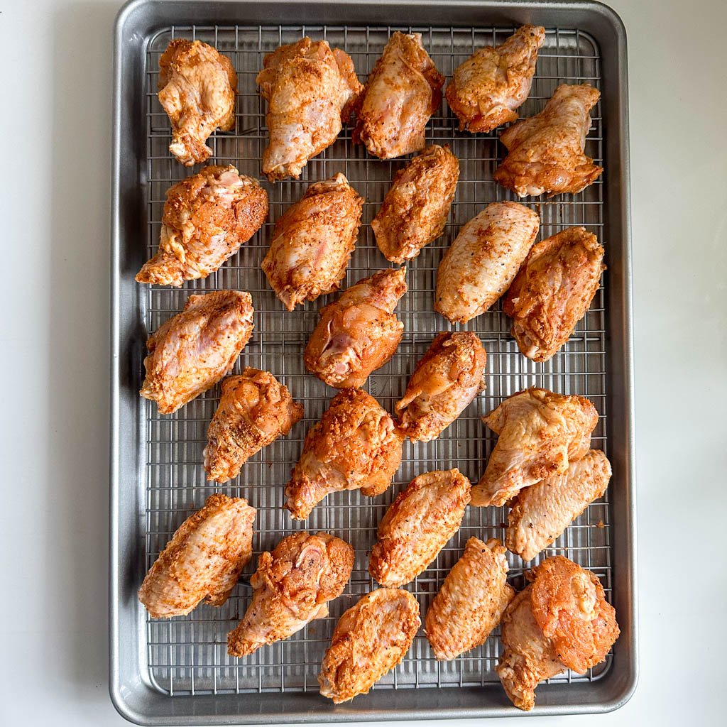 chicken on a wire racked lined baking sheet tray