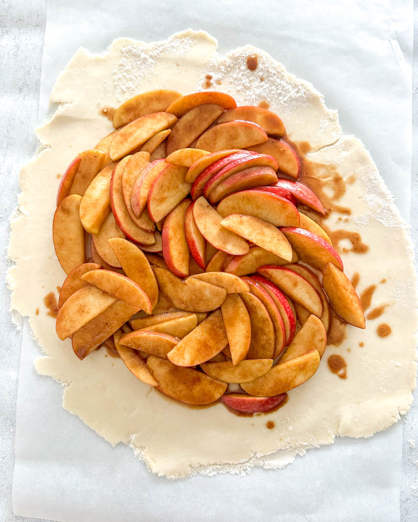 apple filling in the center of galette crust before baking