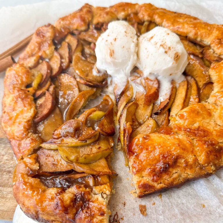 gluten free apple galette topped with ice cream with a slice cut out