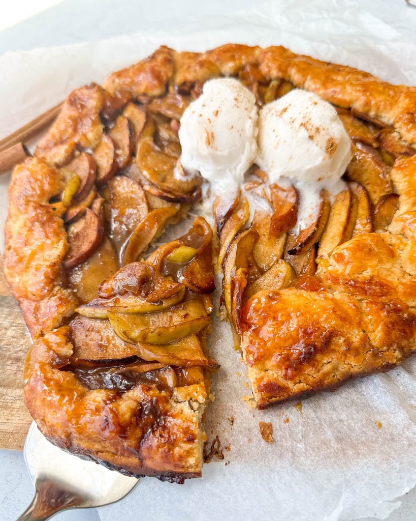 gluten free apple galette topped with ice cream with a slice cut out