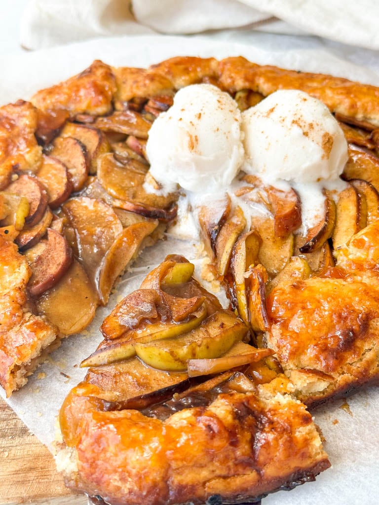 apple galette topped with ice cream with a slice cut out