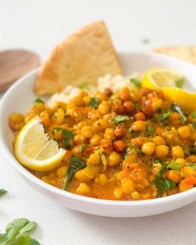 a white bowl filled with coconut chickpea curry