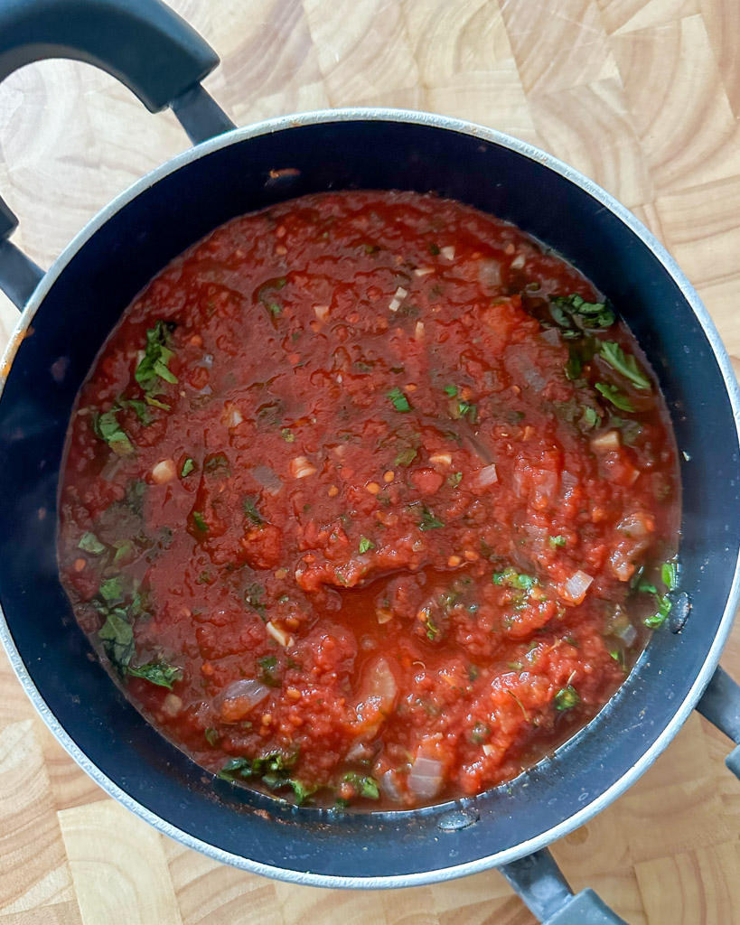 a saucepan filled with ingredients to make marinara sauce
