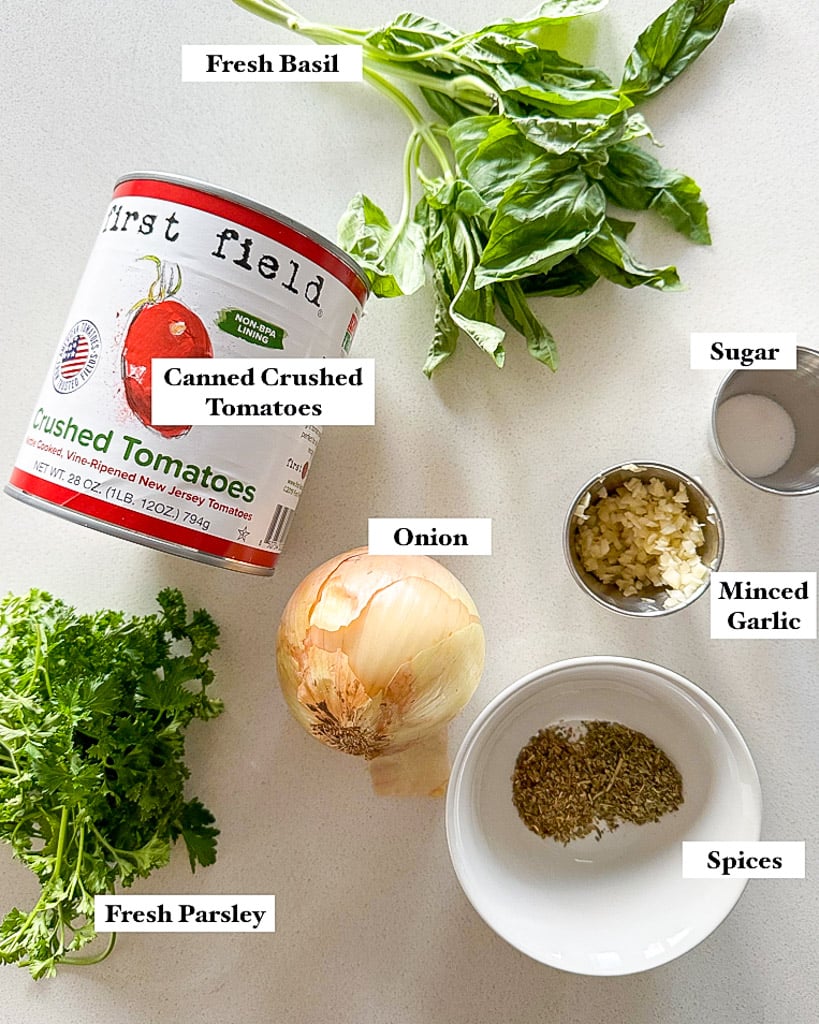 ingredients shown to make homemade marinara sauce shown is fresh basil canned crushed tomatoes onion fresh parsley spices minced garlic sugar and onion