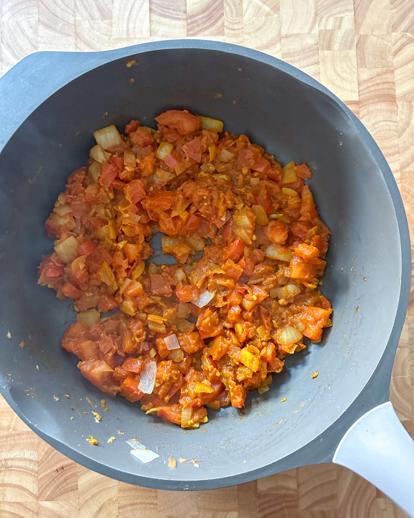 chopped tomatoes onions and spices in a large skillet