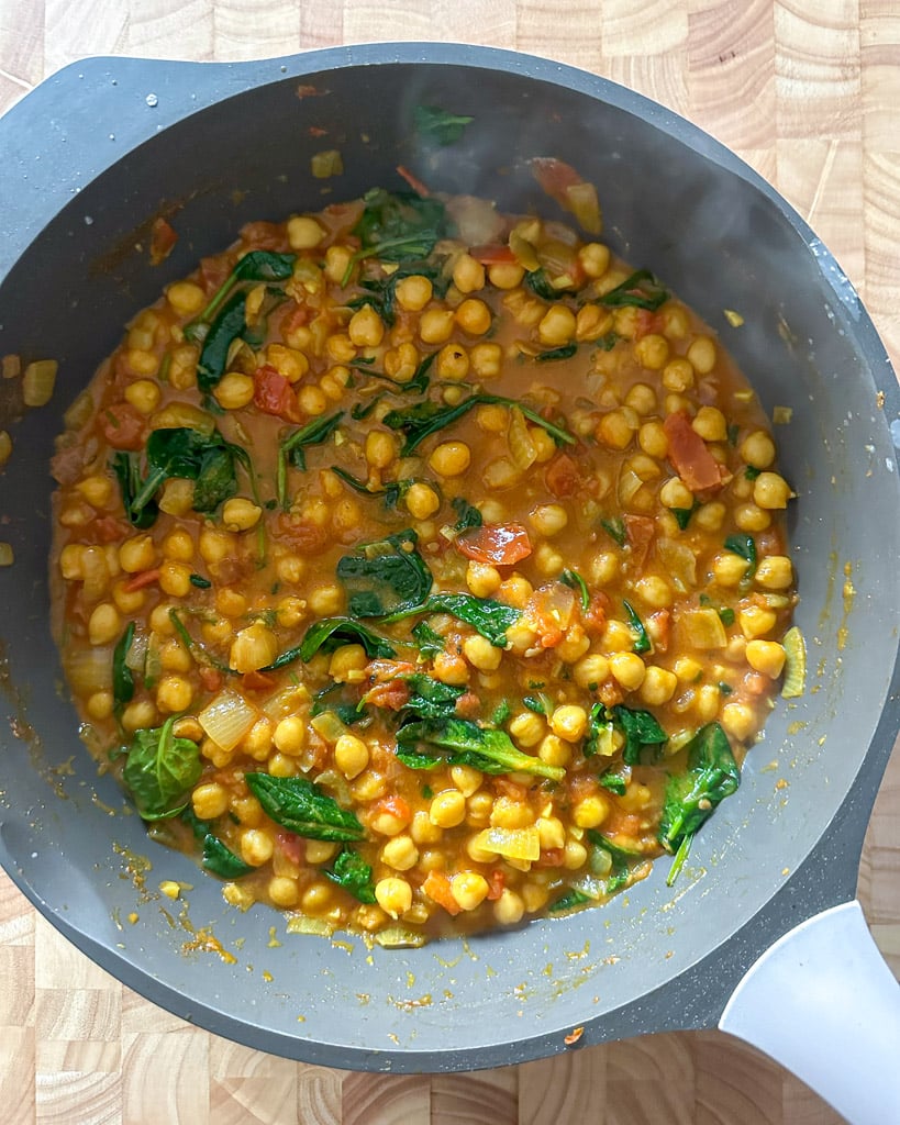 vegan coconut chickpea curry fully cooked in a large skillet
