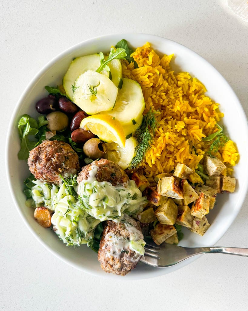 lamb meatballs with tzatziki turmeric rice cucumbers and olives
