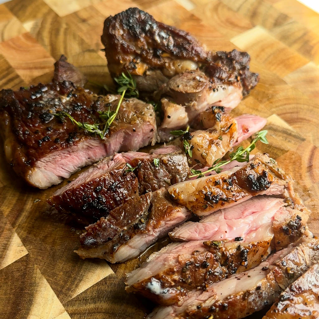 sliced lamb steak on a cutting board
