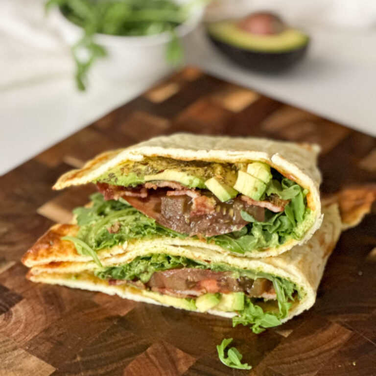 a sandwich made with cottage cheese flatbread on a wooden cutting board