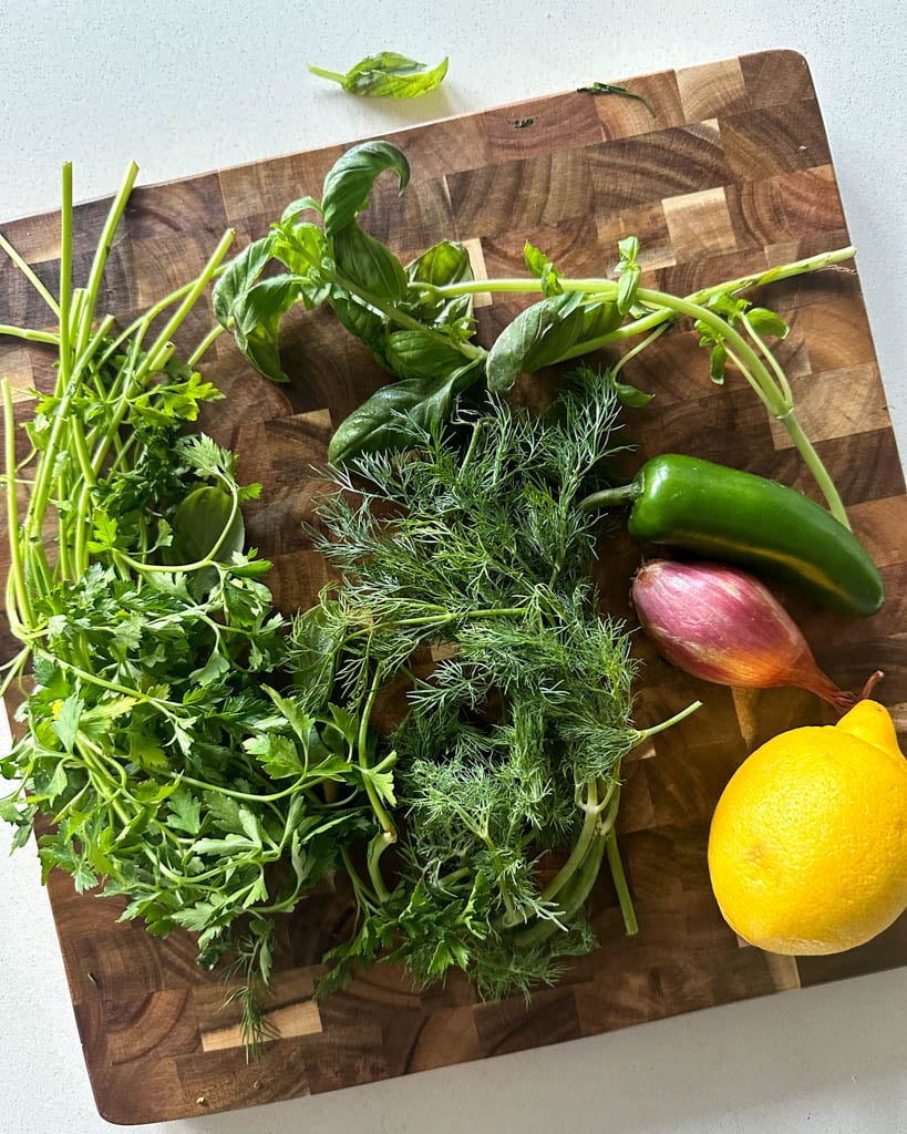 fresh ingredients for herb sauce on cutting board