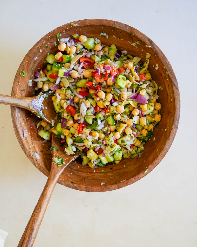 chickpea cucumber salad in a large wooden bowl