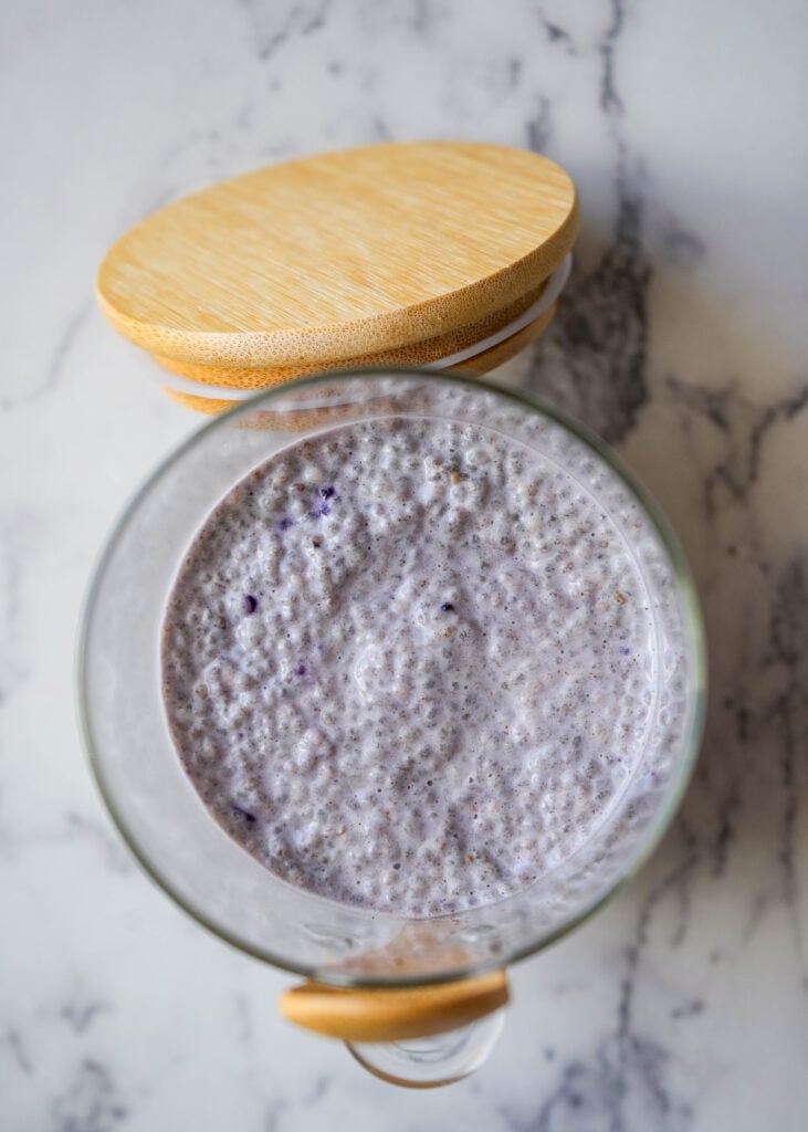 blueberry chia pudding in a mason jar with a wooden lid