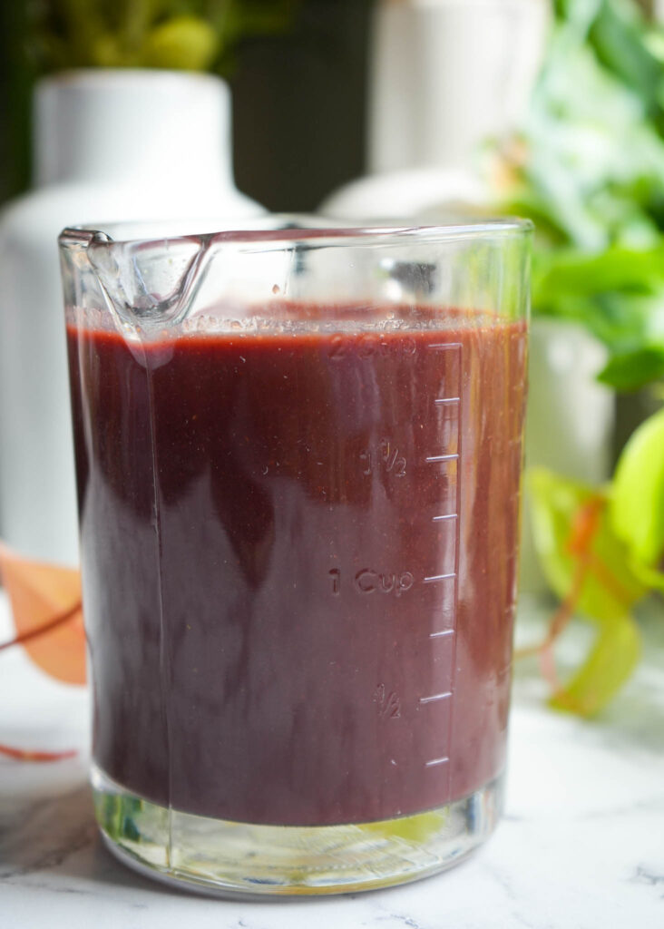 combined elderberry liquid with citrus liquid in a measuring cup