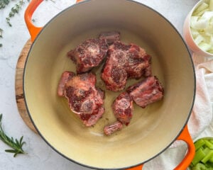 seasoned raw oxtail in a dutch oven