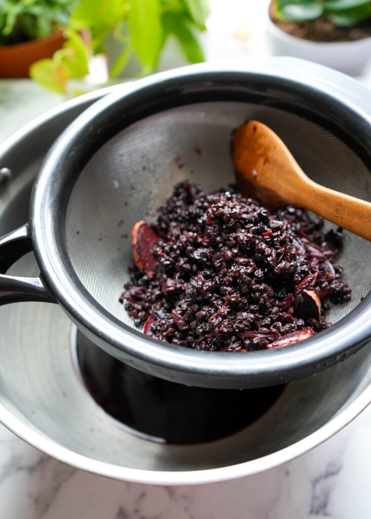 straining elderberries