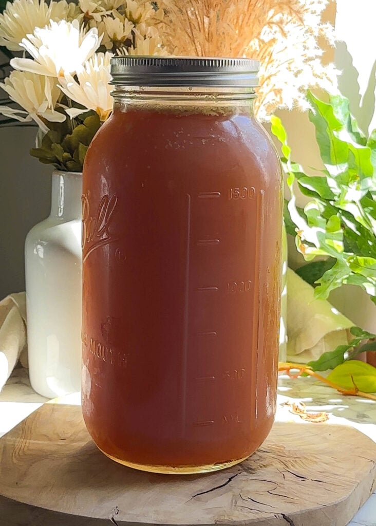 64 ounce mason jar filled with beef bone broth