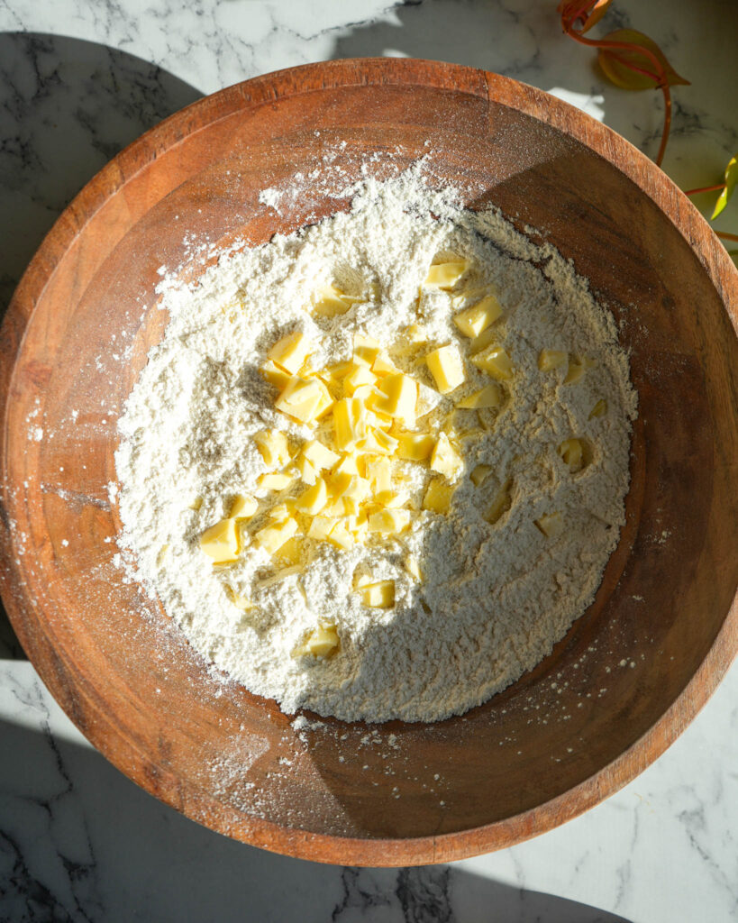 flour and sliced butter in a bowl